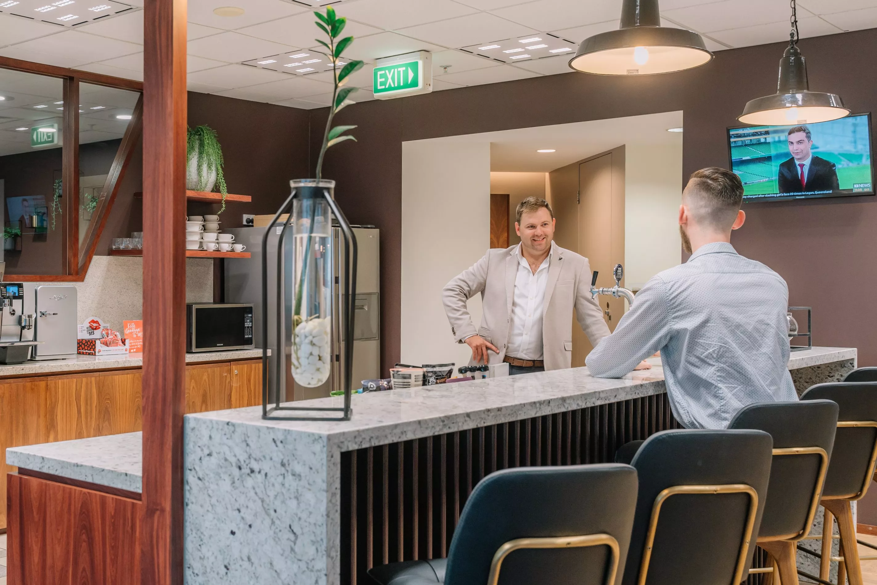 Clients enjoying the fully fitted kitchen space in Servcorp 91 King William Street, Adelaide