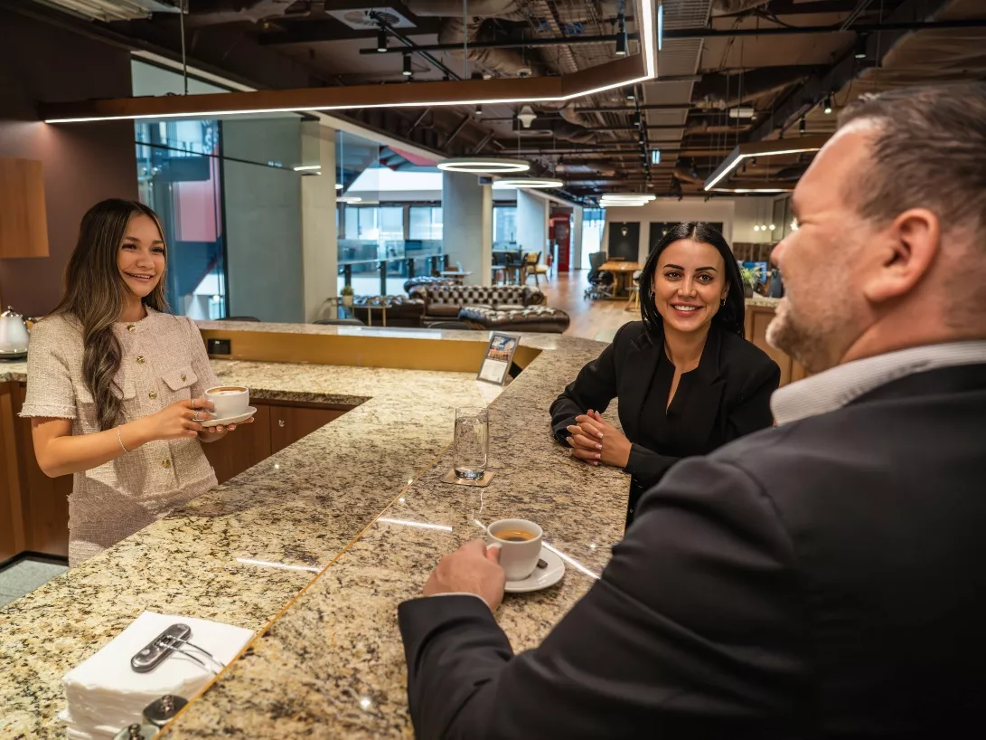People enjoying their time in a modern fully stocked kitchen break room in Servcorp 3 Parramatta Square