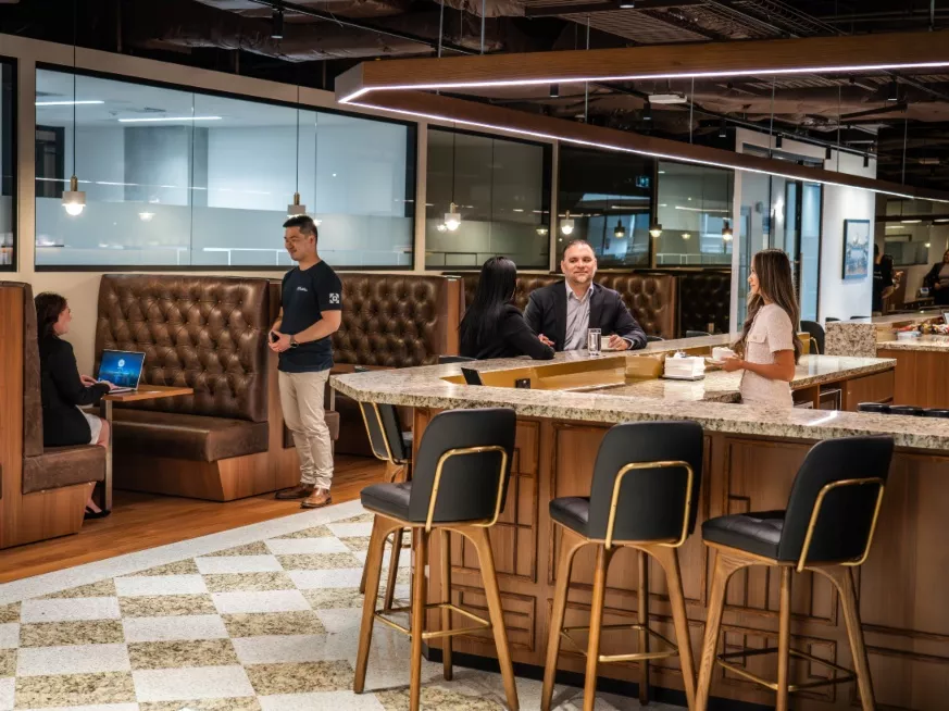 Clients working in the booths and modern fully stocked kitchen of a modern coworking space within Servcorp 3 Parramatta Square
