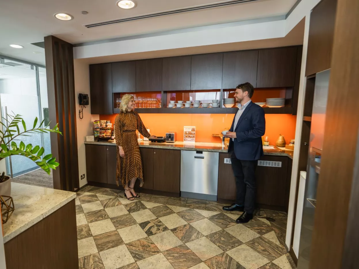 People enjoying their time in a modern fully stocked kitchen break room in Servcorp Westfield Tower 2