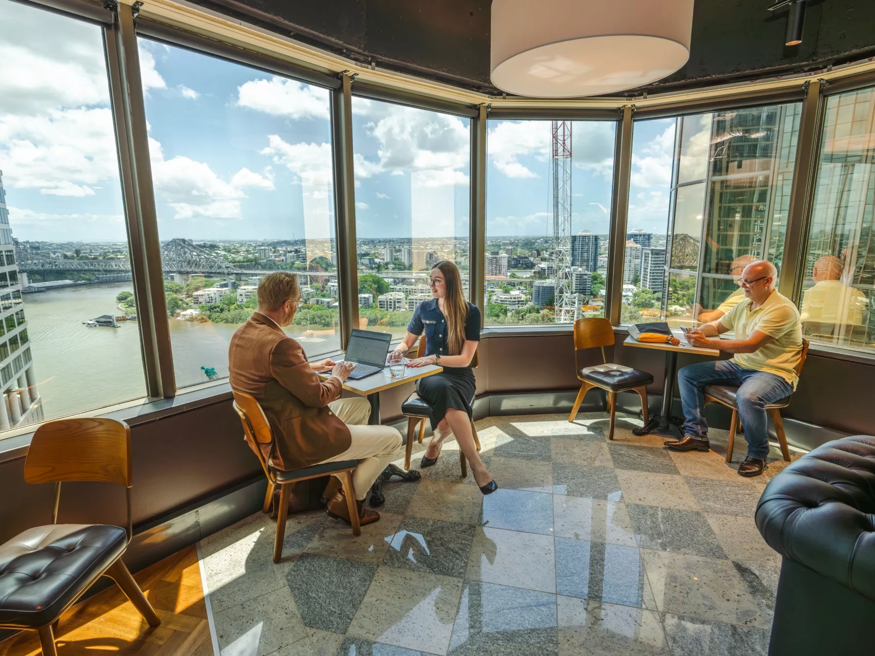 Clients working in a modern coworking space, with impressive views in Servcorp 10 Eagle Street, Brisbane