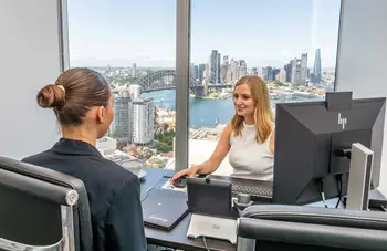 Two clients operating in a fully fitted private serviced office in Servcorp 100 Mount Street
