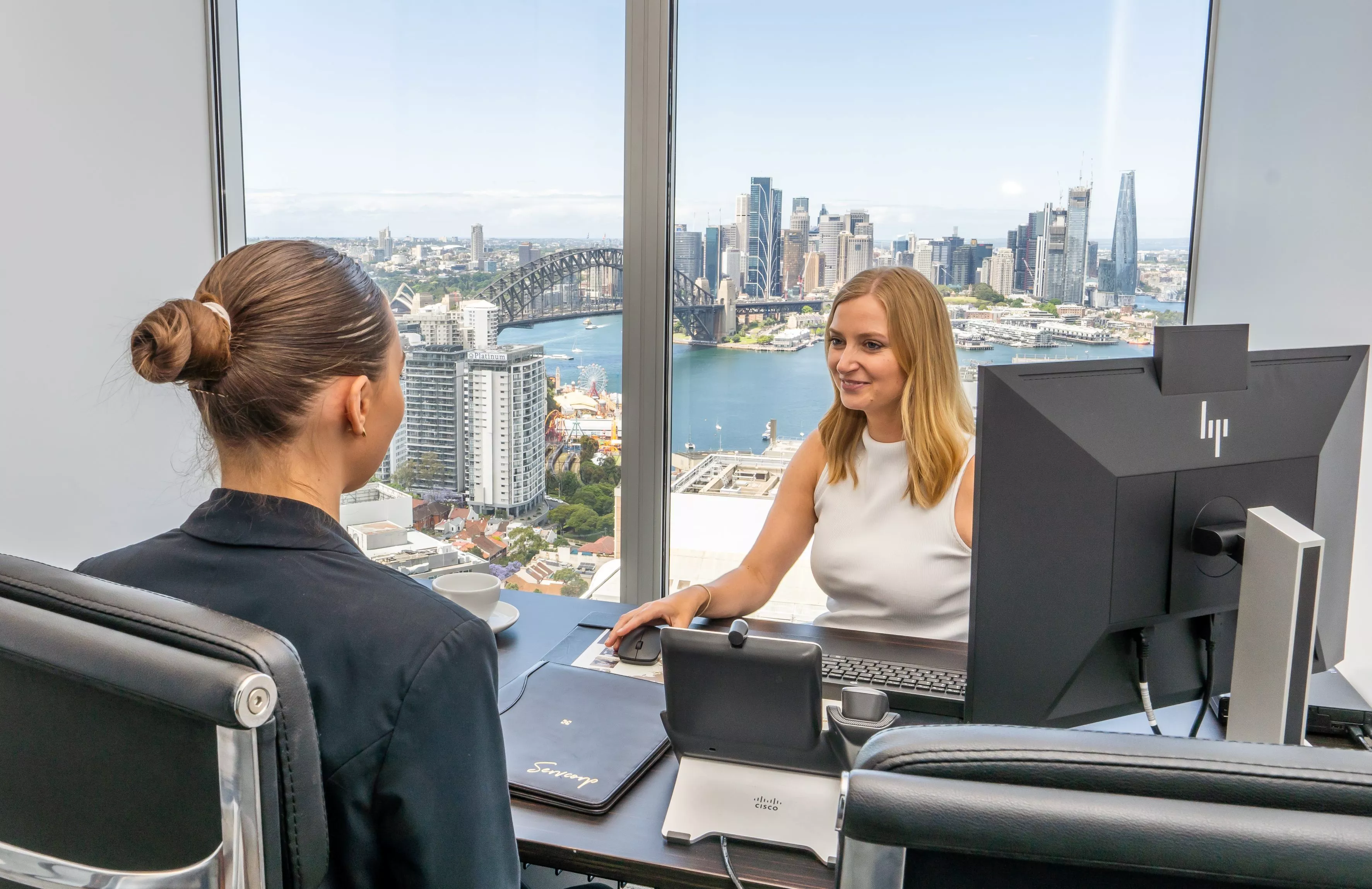 Two clients operating in a fully fitted private serviced office in Servcorp 100 Mount Street