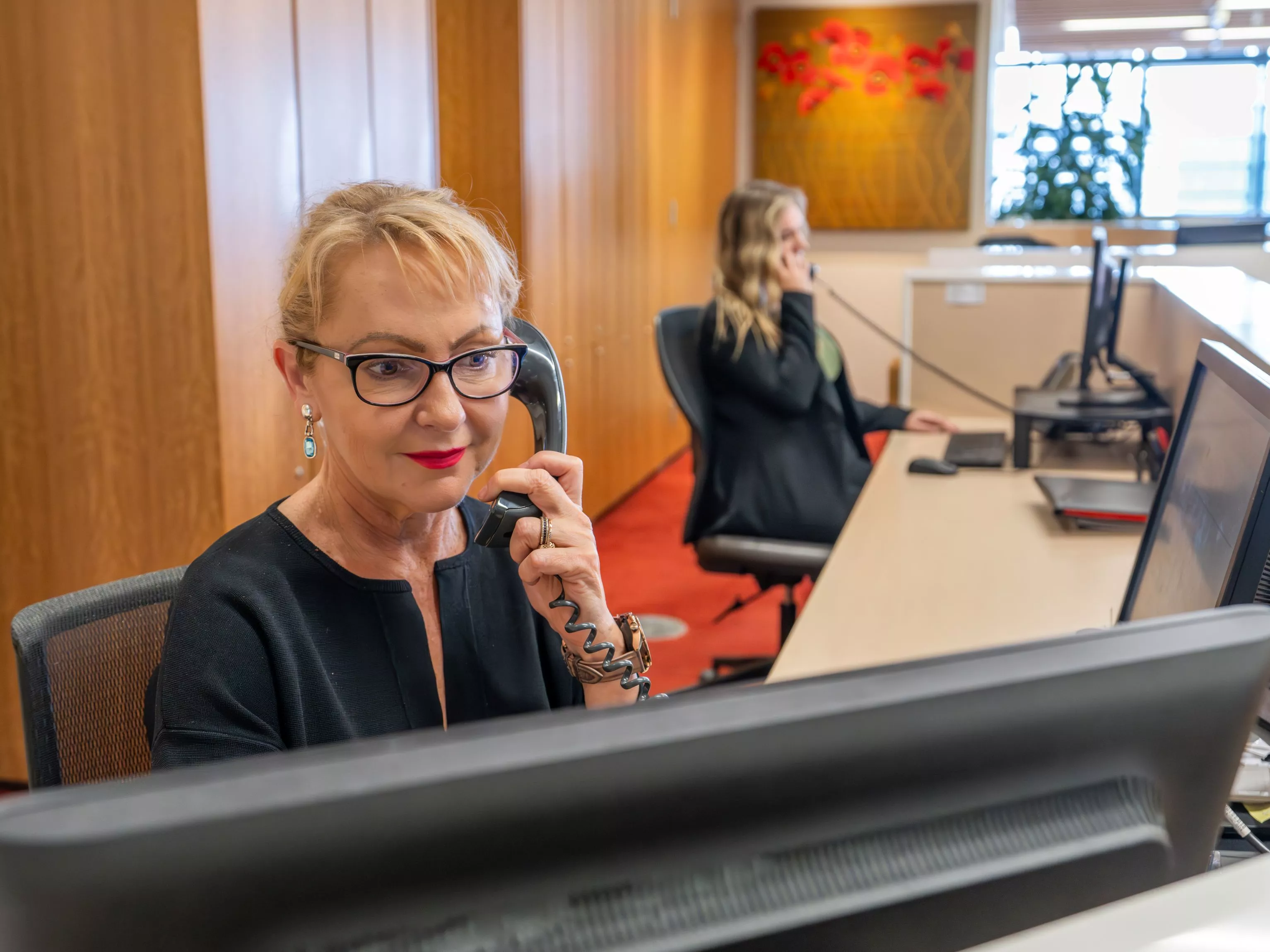 Dedicated receptionist on the phone to a client in Servcorp Nishi Building, Canberra