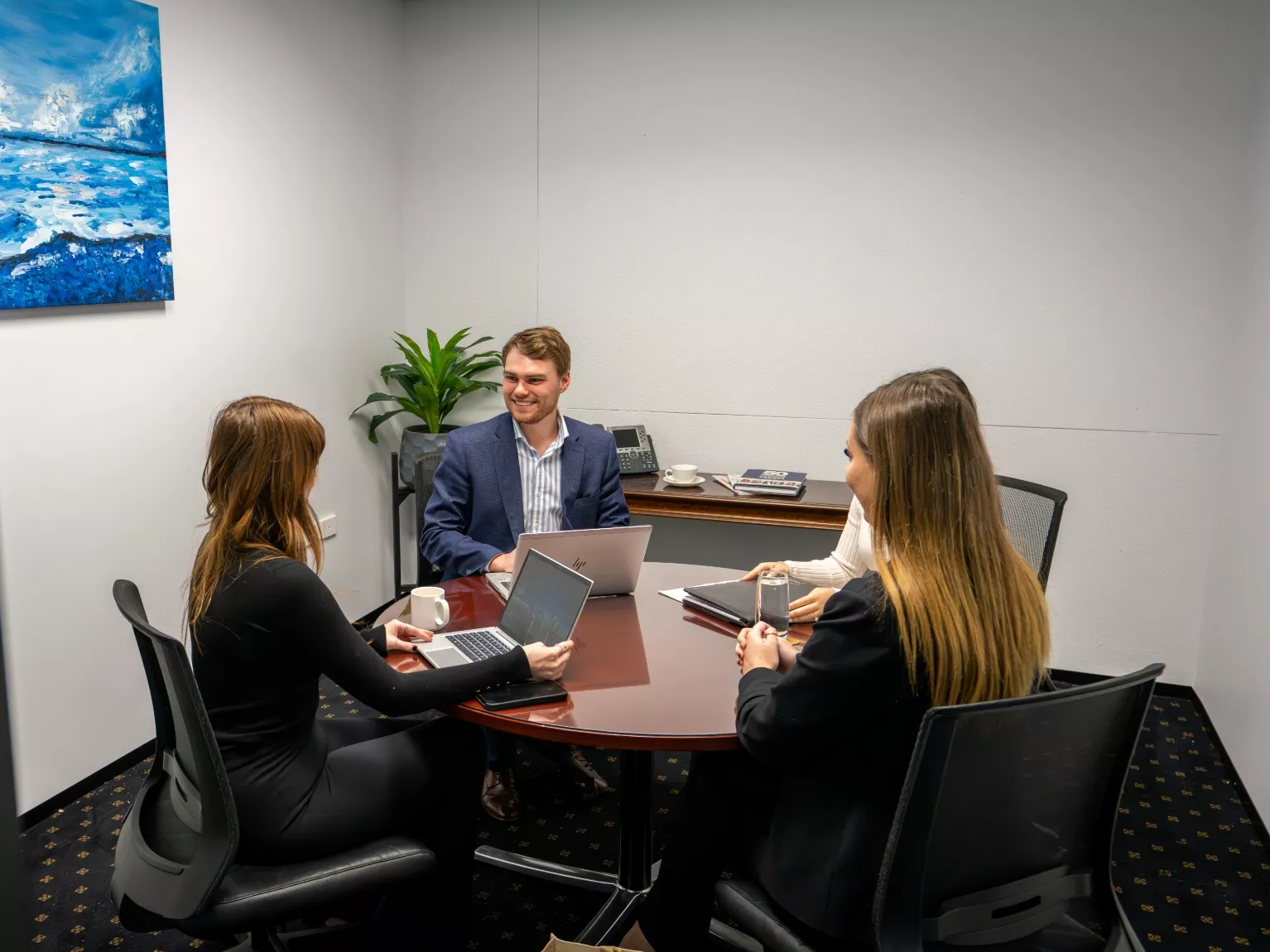 Clients conversing in a modern fully equipped office environment meeting room space in Servcorp 25 Martin Place