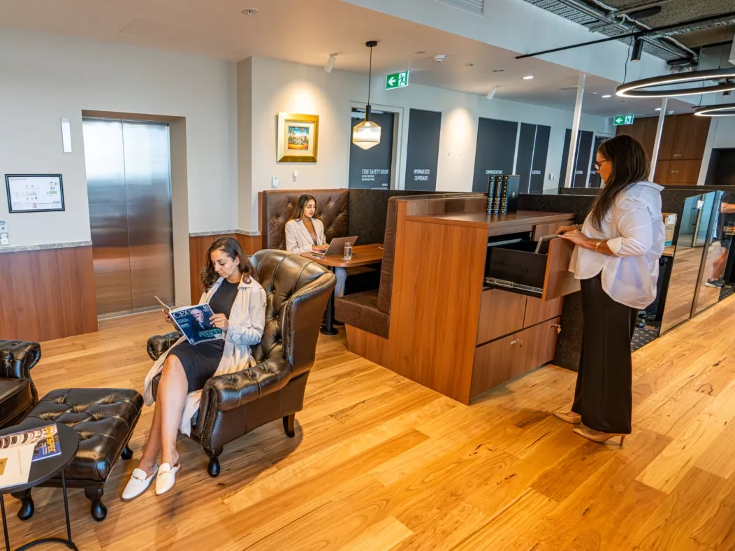 Clients in a modern coworking space and in the booths in Servcorp 263 William Street, Melbourne