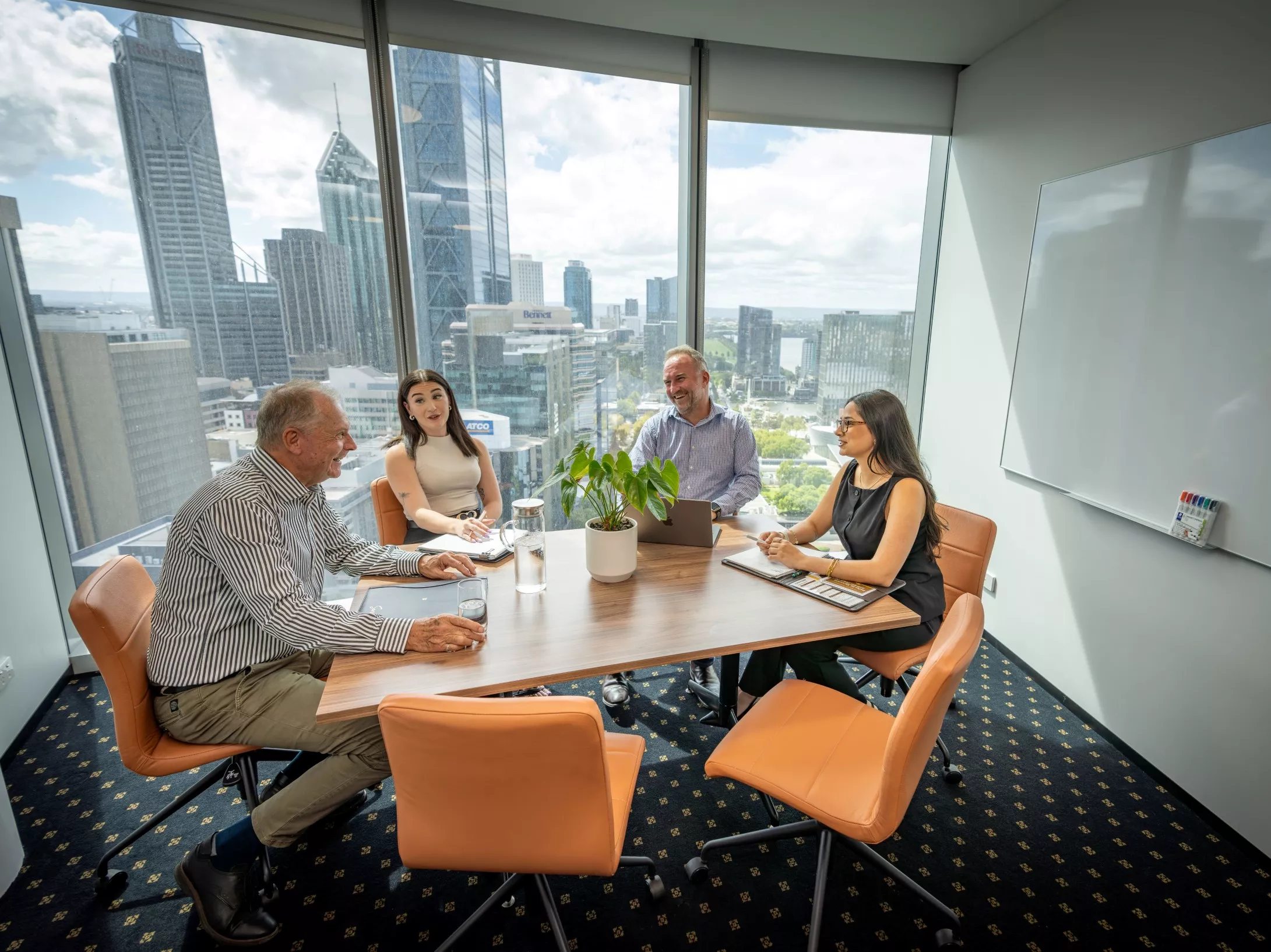 A client talking to her clients in a modern meeting room space with impressive views in Servcorp Capital Square Tower 3 Perth